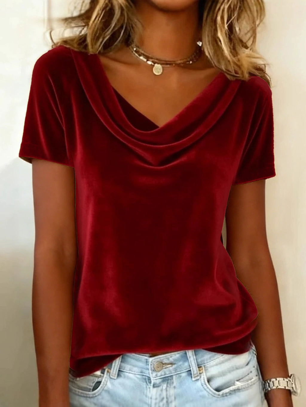 Red velvet top worn by a person with a neutral background