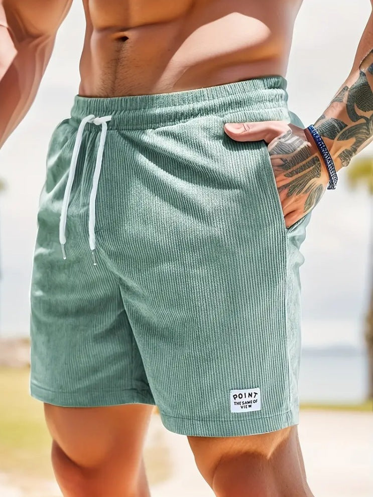 Person wearing green shorts with a blurred background