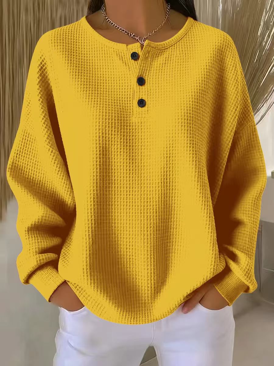 Yellow textured sweater worn by a person with a neutral background