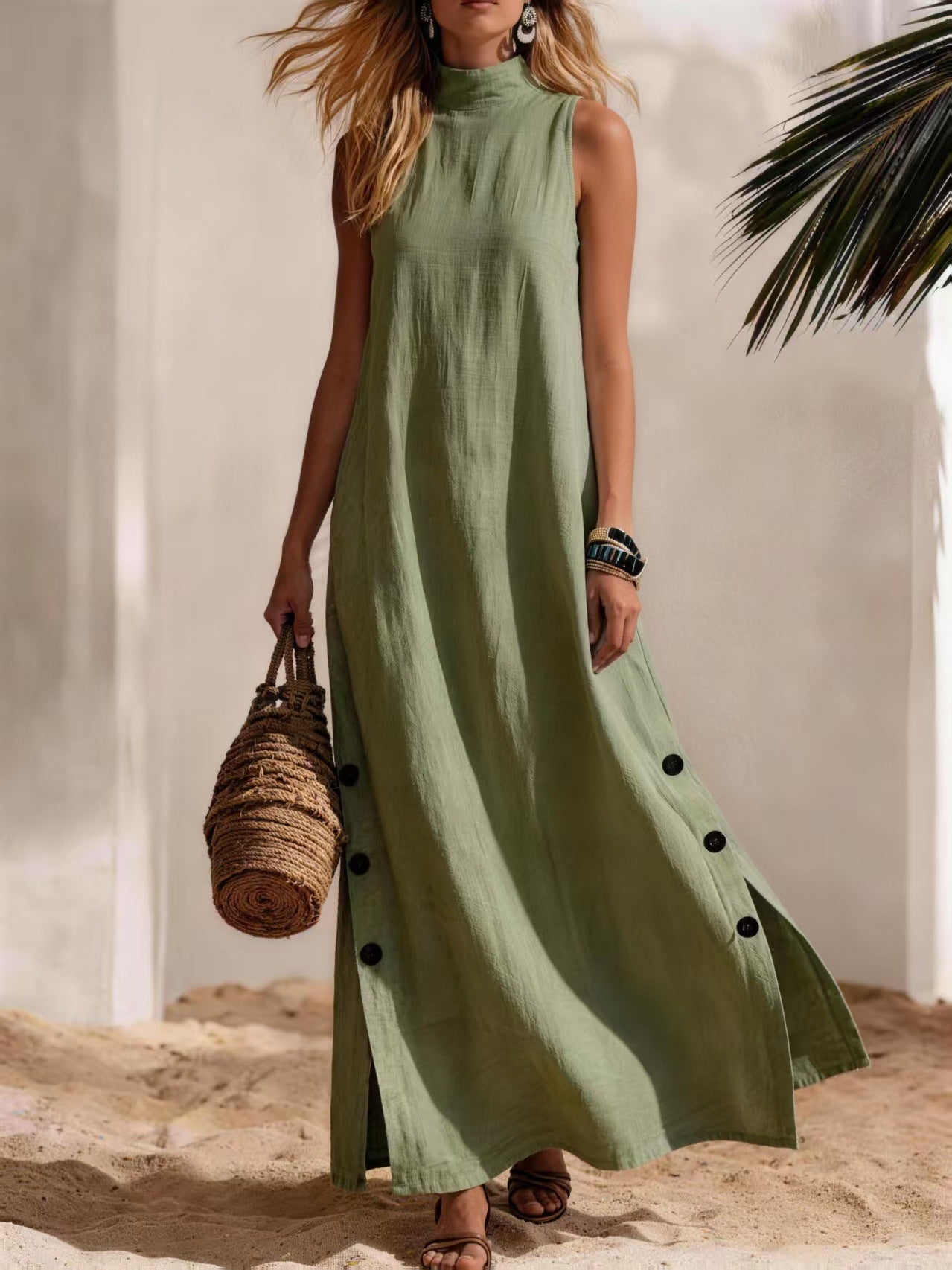 Woman wearing a green dress with black buttons on a beach