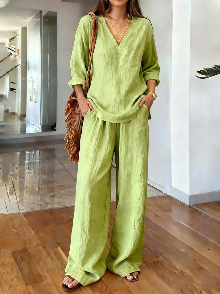 Person wearing a light green outfit in a modern indoor setting