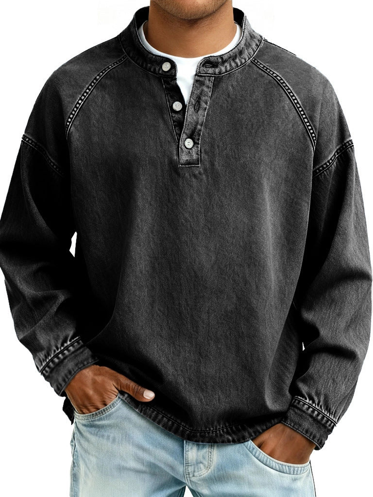 Person wearing a black denim shirt with white buttons on a white background
