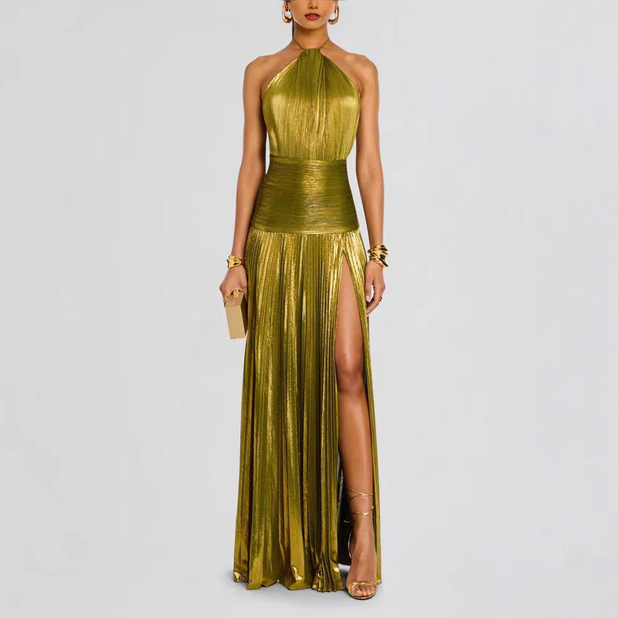 Woman wearing a gold metallic halter neck gown with a slit on a light gray background