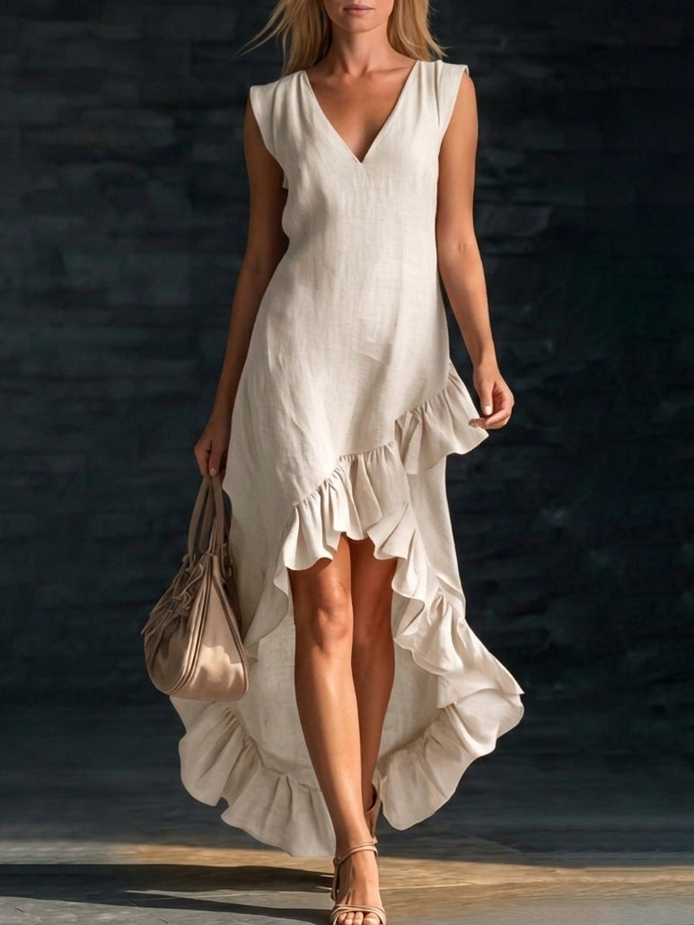 Woman wearing a white dress with ruffles against a dark background