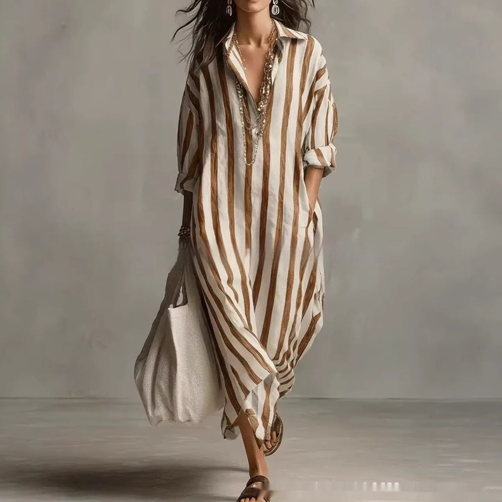 Woman wearing a long, striped dress with a neutral background