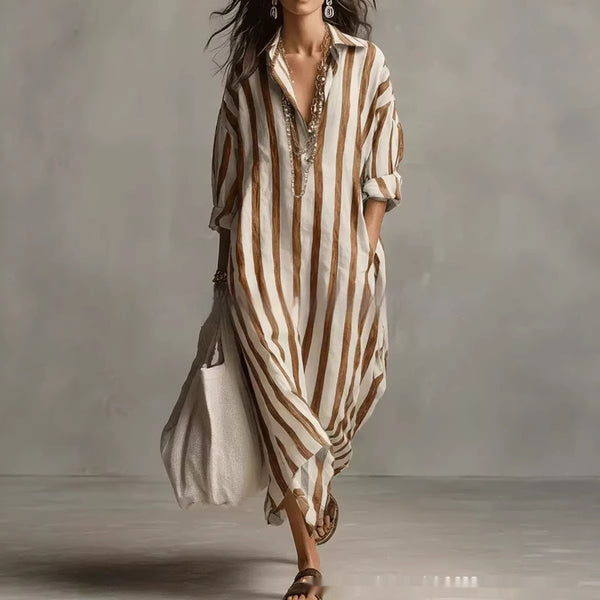 Woman wearing a long, striped dress with a neutral background