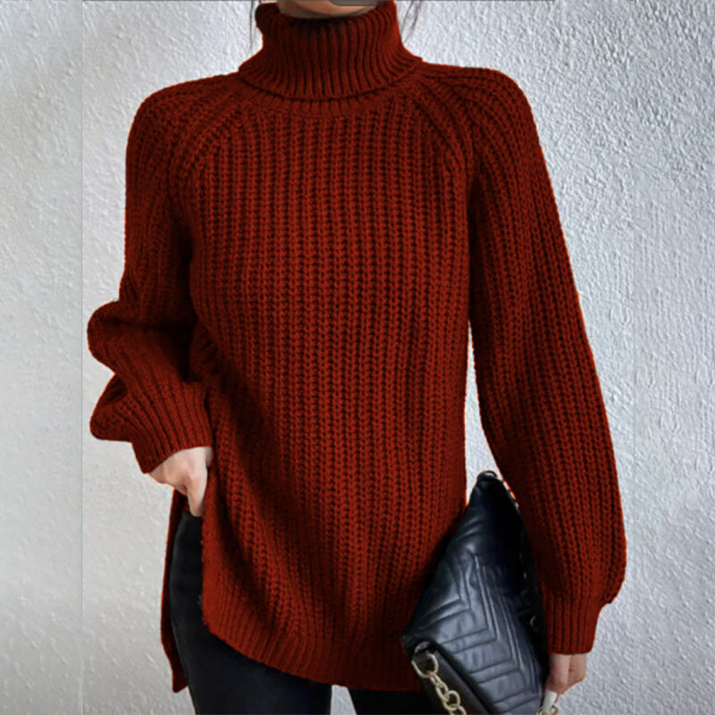 Person wearing a rust-colored knitted sweater against a plain background