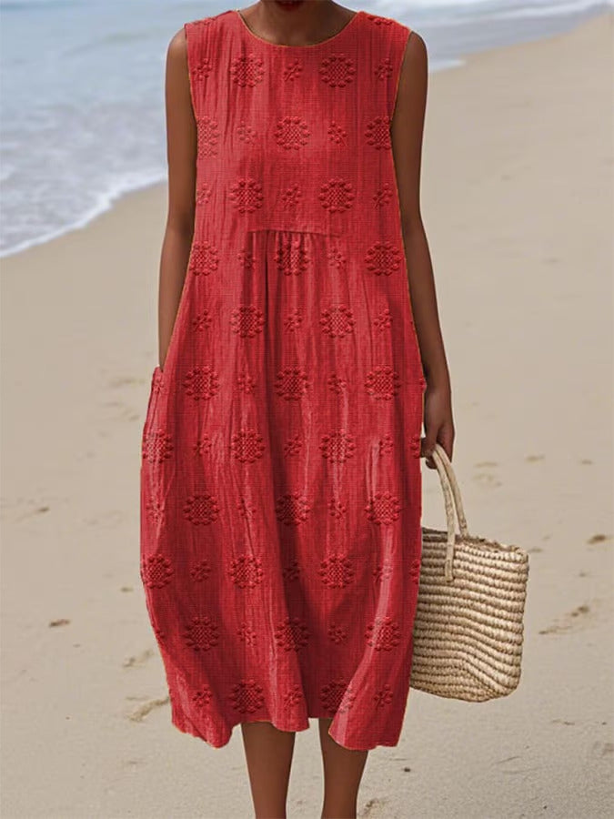 Person wearing a red dress on a beach