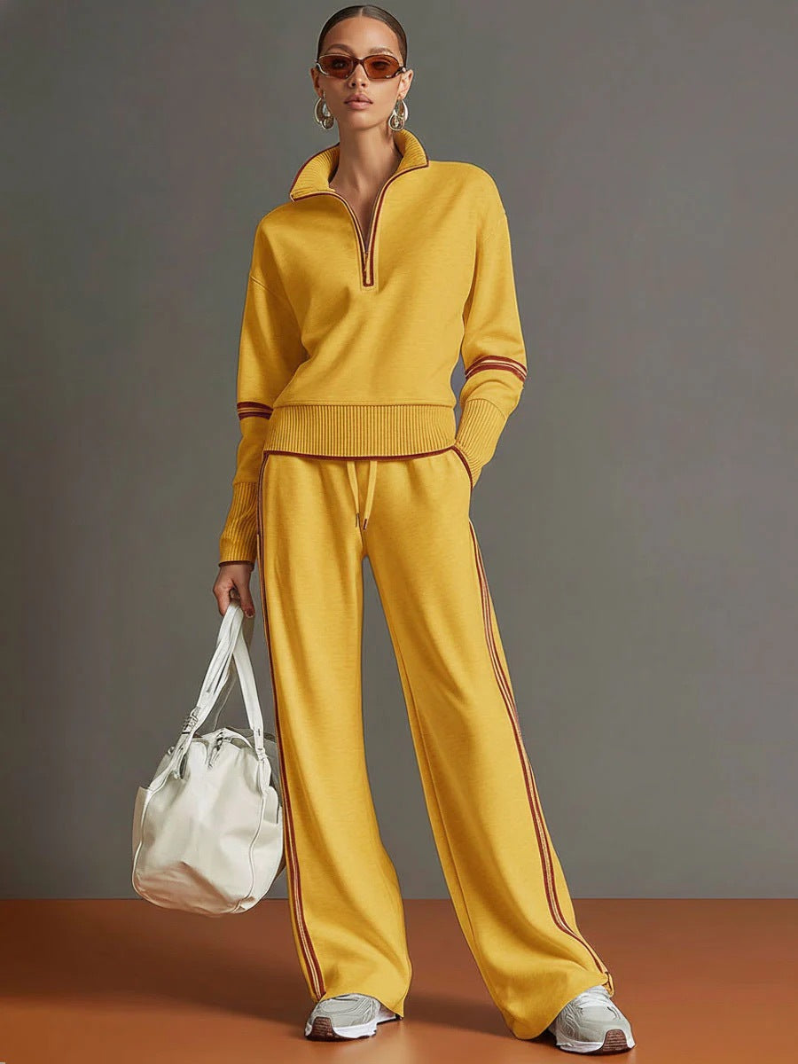 Person wearing a yellow tracksuit with a white bag against a gray background