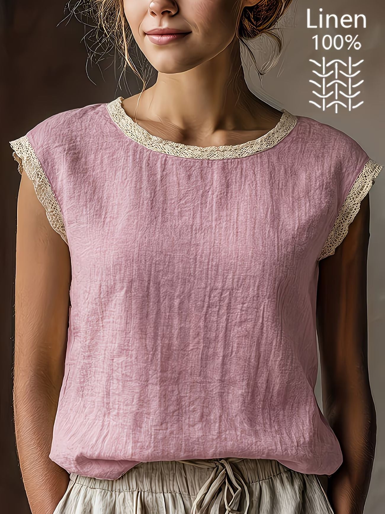 Woman wearing a pink linen top with lace trim, against a neutral background.