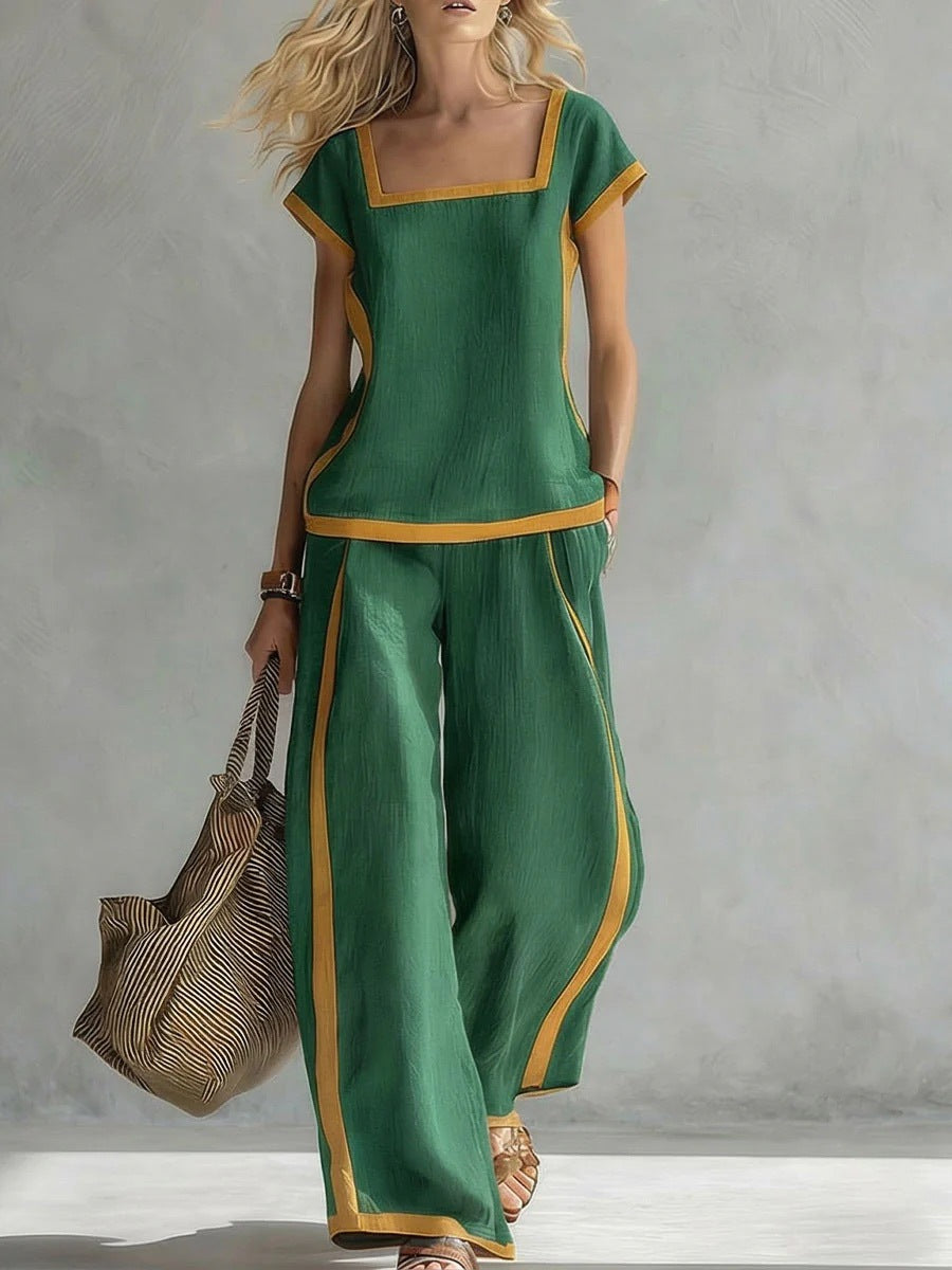 Woman wearing a green outfit with yellow accents against a gray background