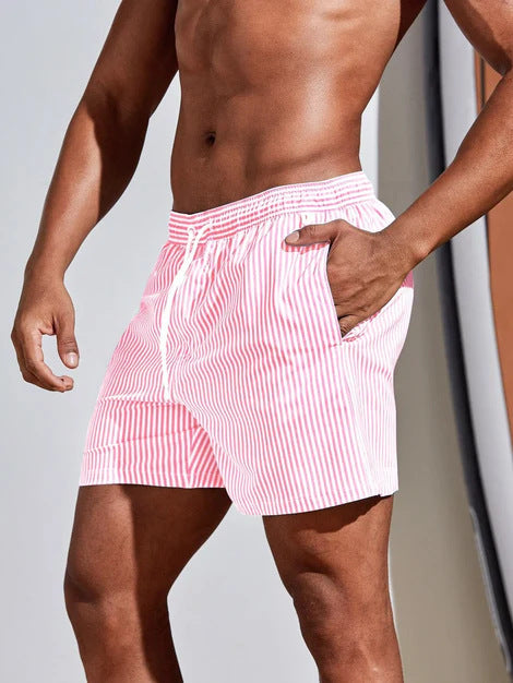 Person wearing red and white striped swim shorts against a neutral background