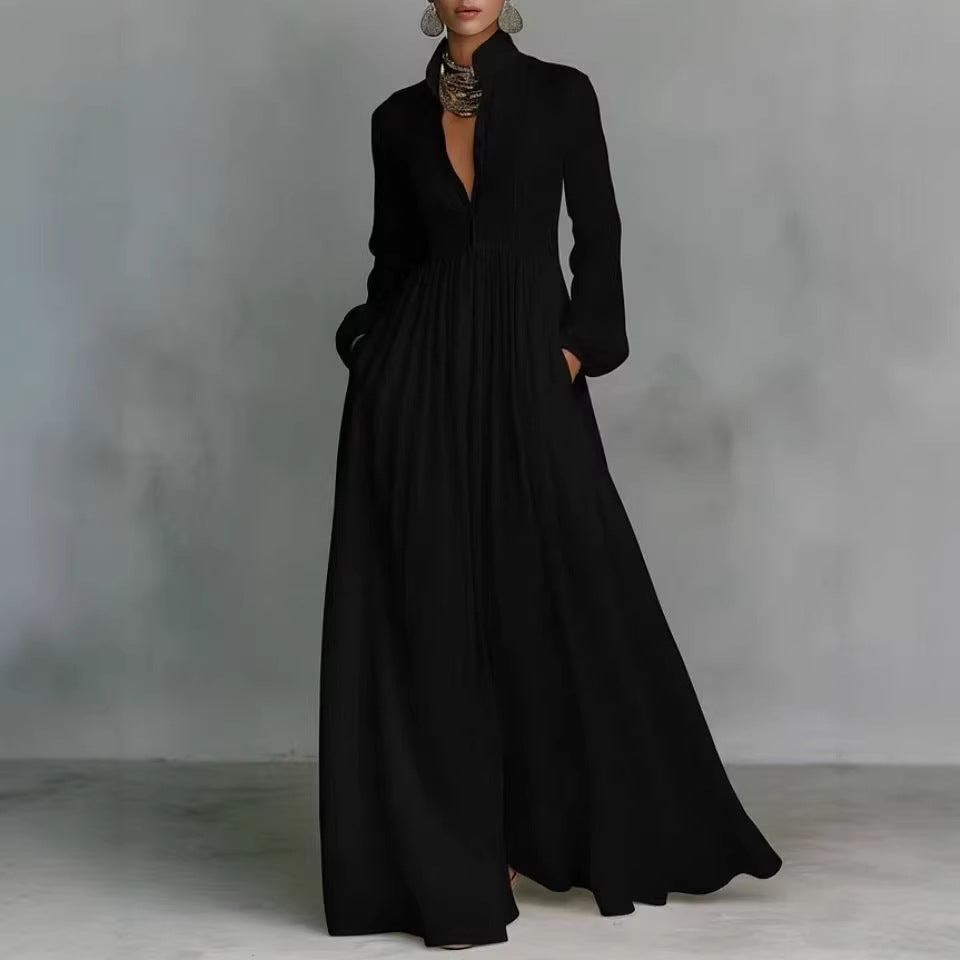 Long black dress worn by a model against a gray background