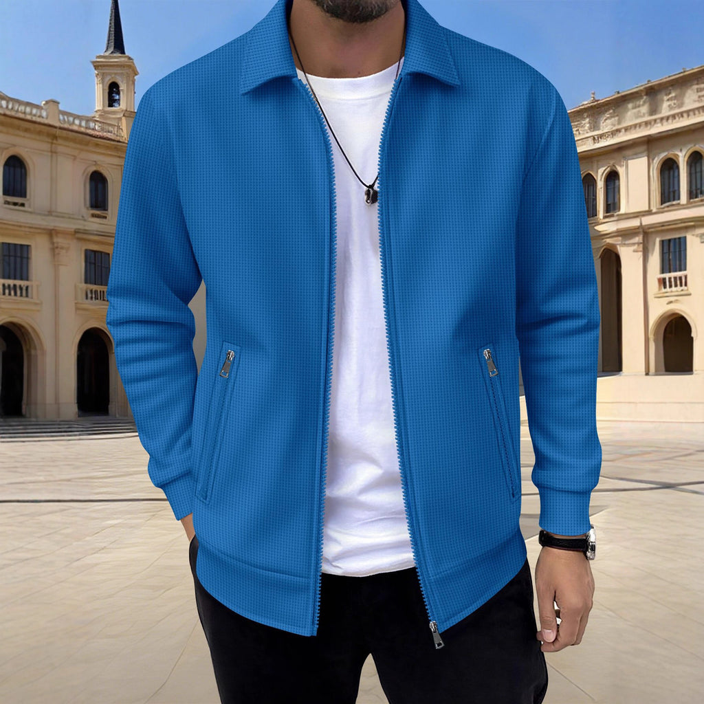 Person wearing a blue jacket over a white shirt with a classical building in the background