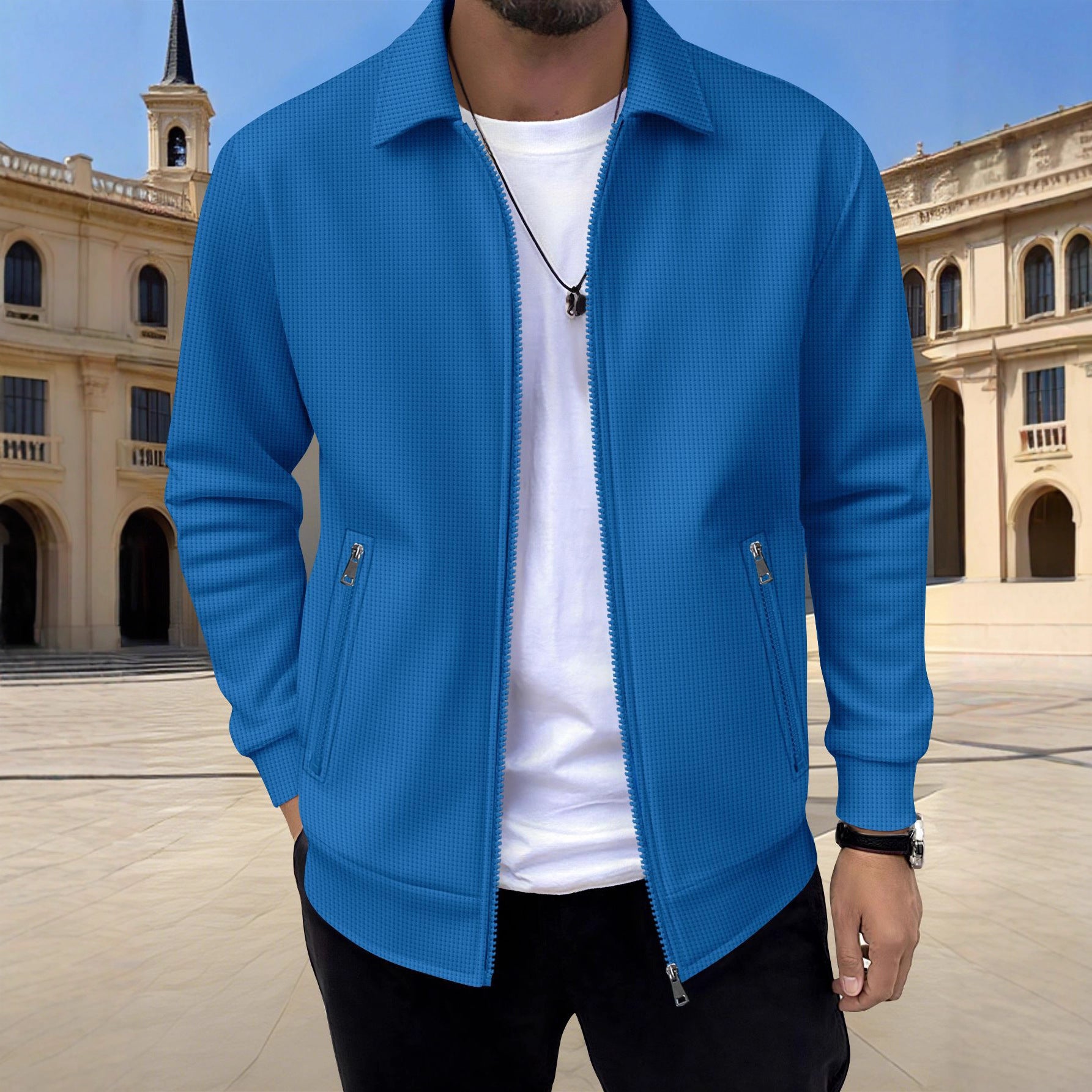 Person wearing a blue jacket over a white shirt with a classical building in the background