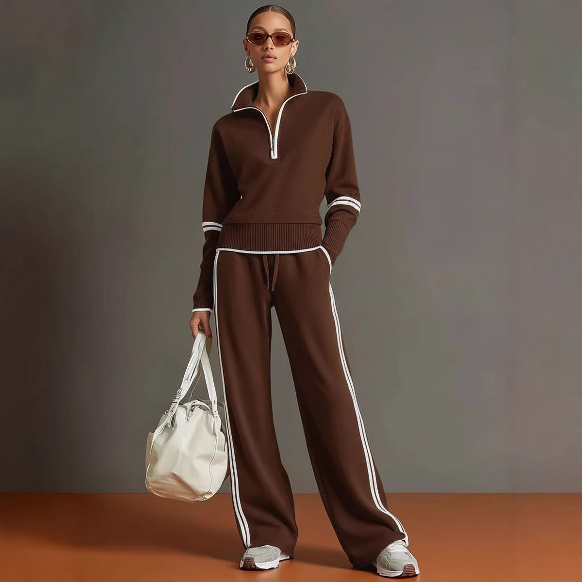 Woman wearing a brown tracksuit with white stripes on a gradient background