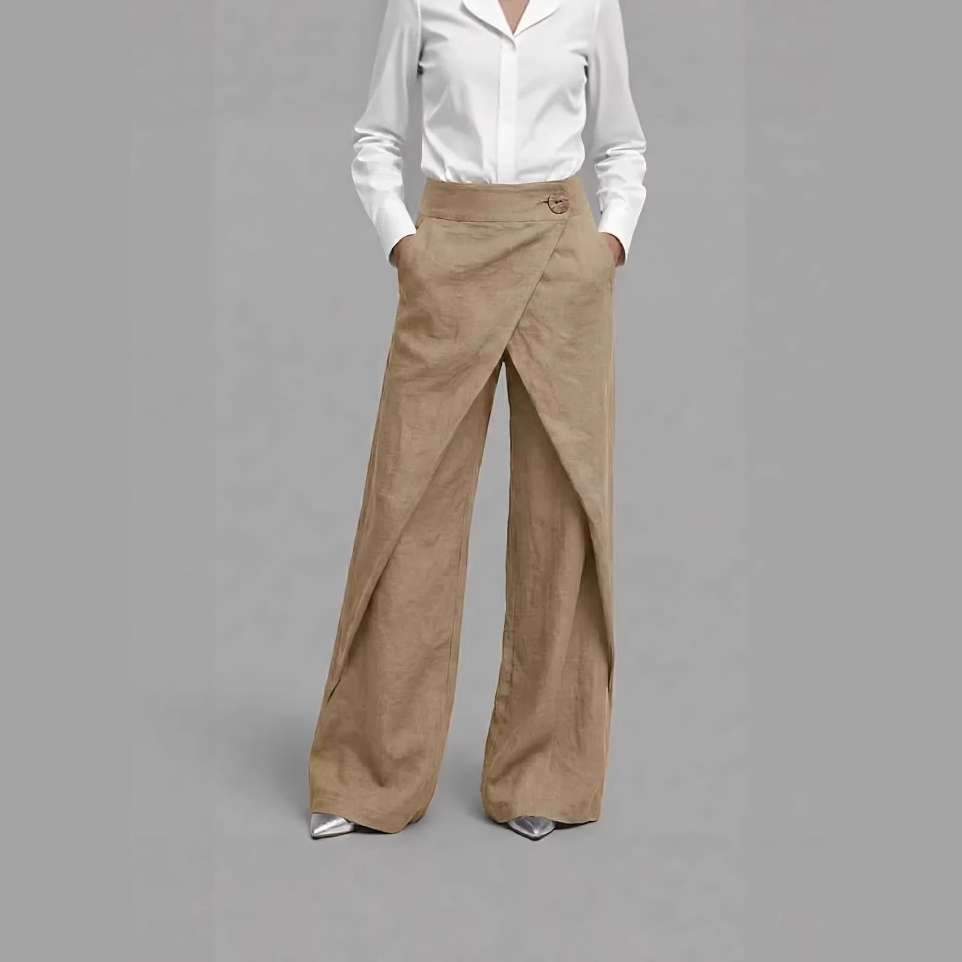 Person wearing a white shirt and beige wide-leg pants on a gray background