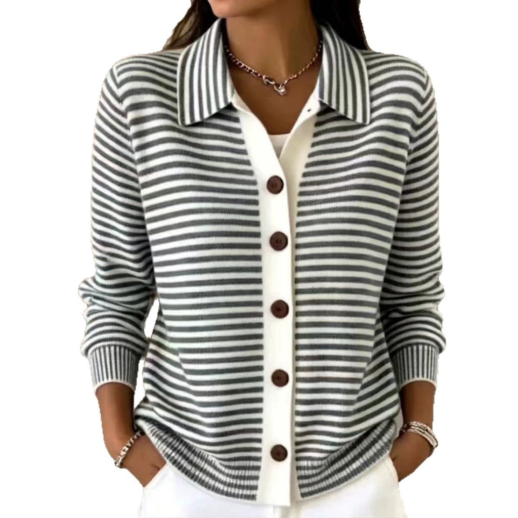 A woman wearing a gray and white horizontally striped knit cardigan with a white button placket and dark brown buttons, layered over a white top.