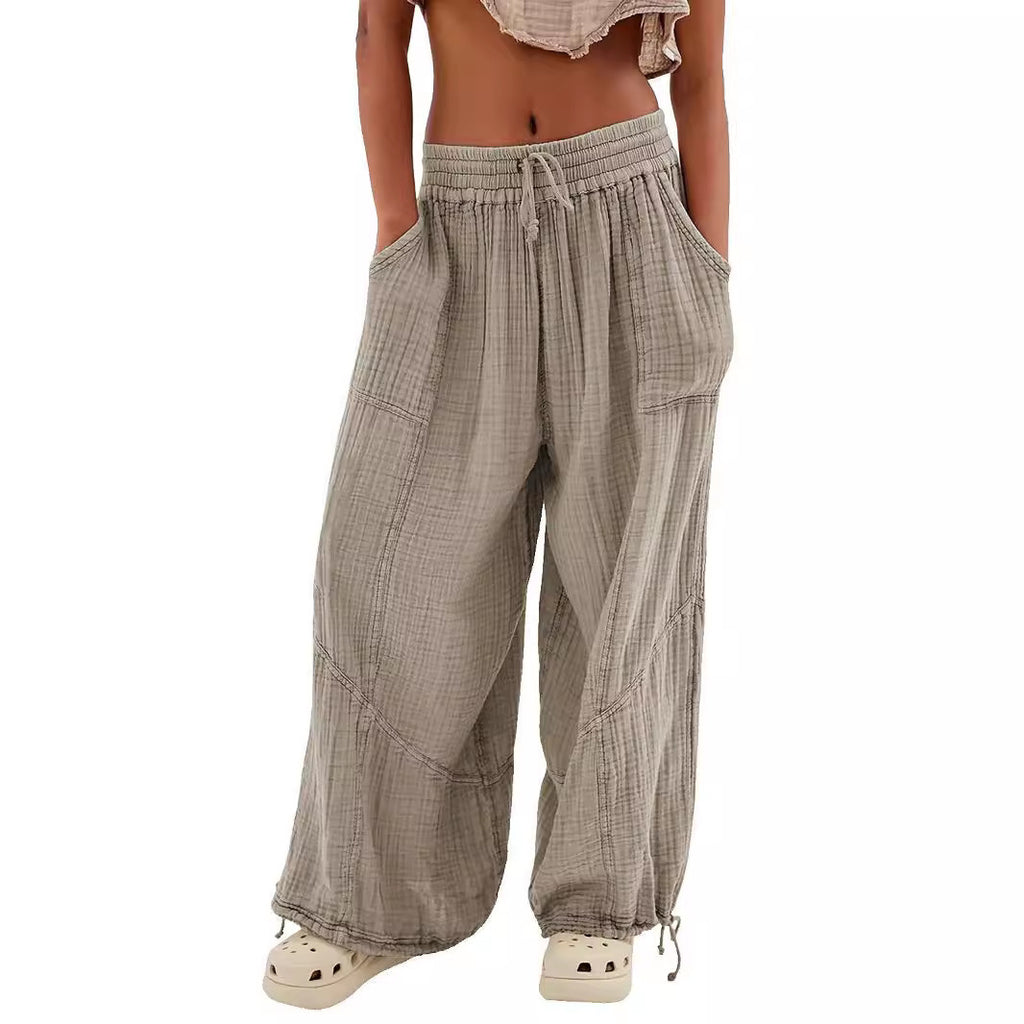 Plaid wide-leg pants worn by a person on a white background