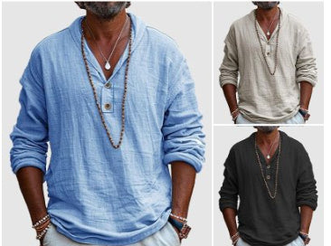 Three men wearing long-sleeve shirts in blue, beige, and black with necklaces.