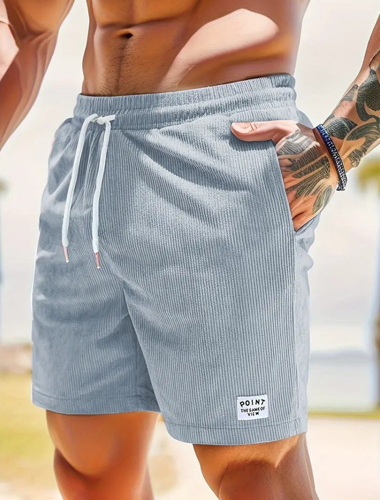 Person wearing light blue striped shorts with a blurred background