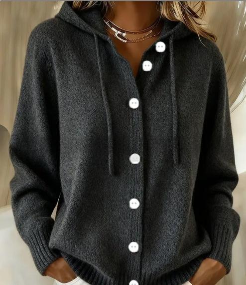 A dark gray knit cardigan hoodie with a button-up front, drawstrings, and white buttons, worn by a model.