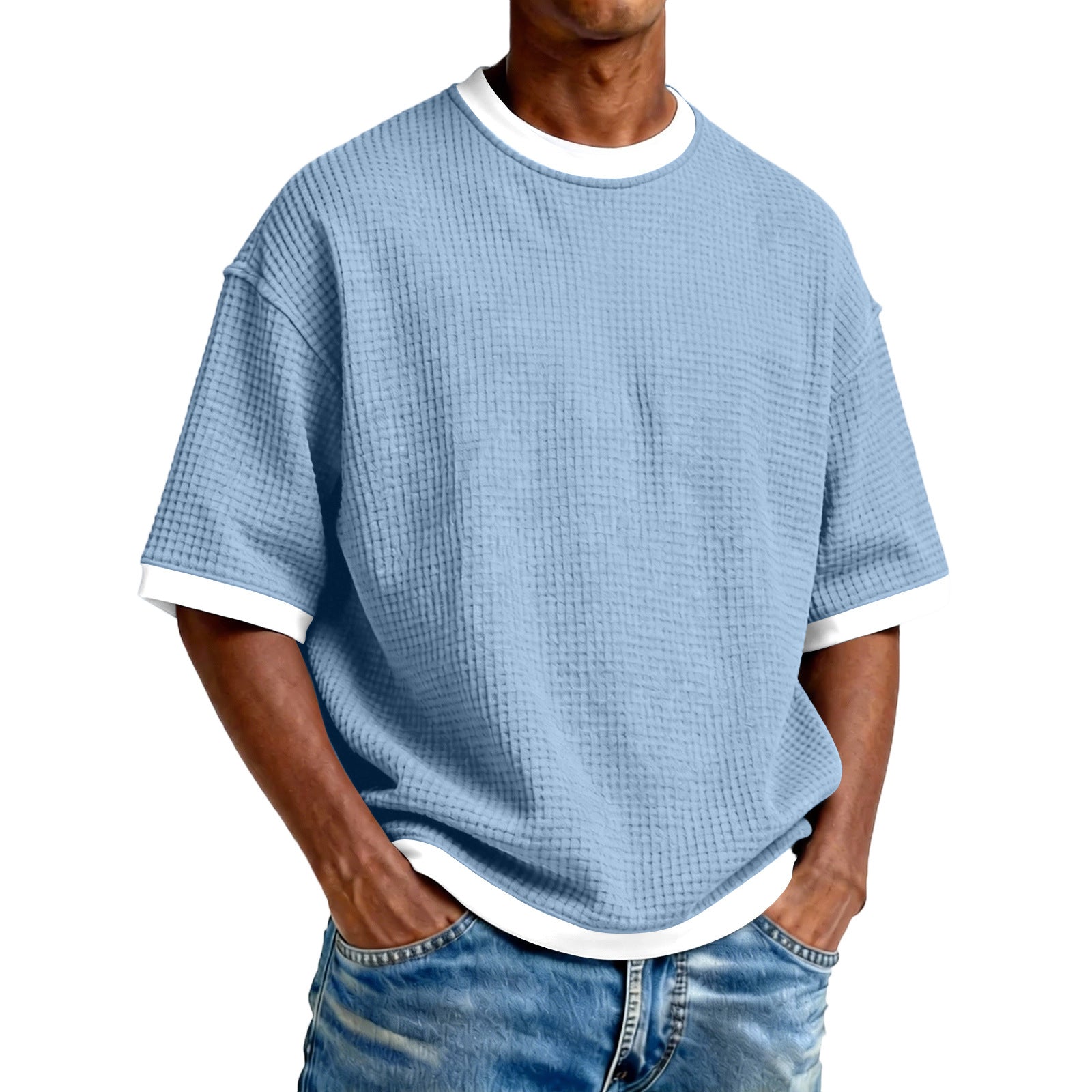 Person wearing a blue textured t-shirt with white trim on a white background
