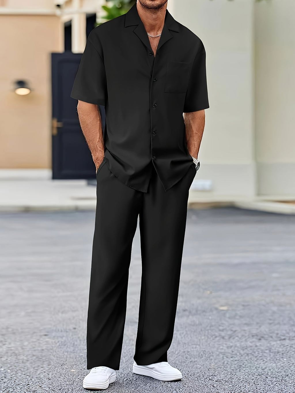 Person wearing a black outfit with white shoes in an outdoor setting