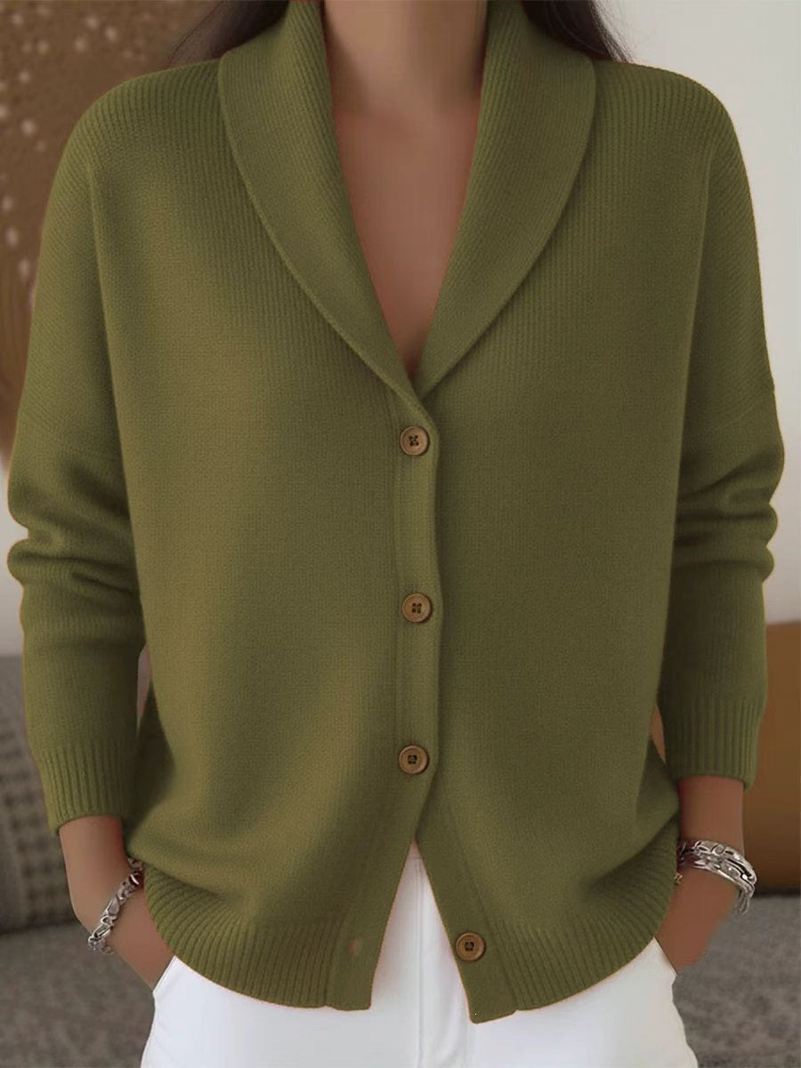 Green cardigan worn by a person with a neutral background