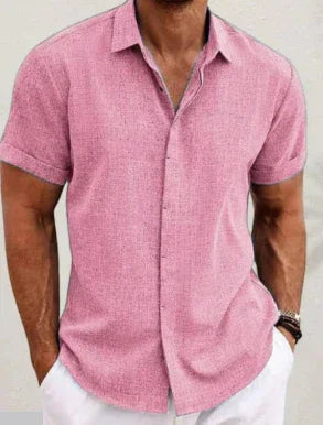 Man wearing a pink short-sleeve shirt against a neutral background