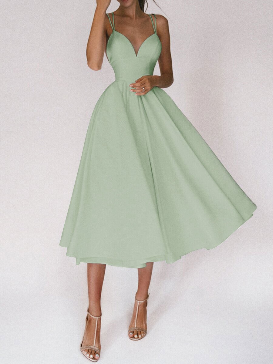 Green dress being worn on a white background