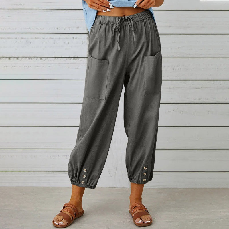 Gray wide-leg pants worn by a person against a wooden background