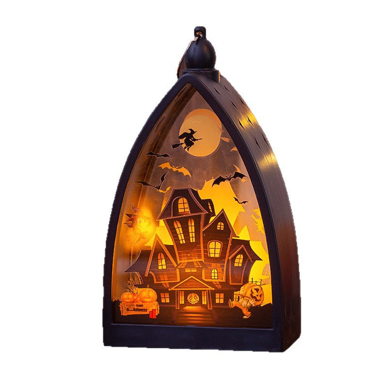 Halloween arched window light featuring a detailed haunted house scene with bats, a witch on a broomstick, a pumpkin, and a full moon, illuminated in warm orange and yellow tones.