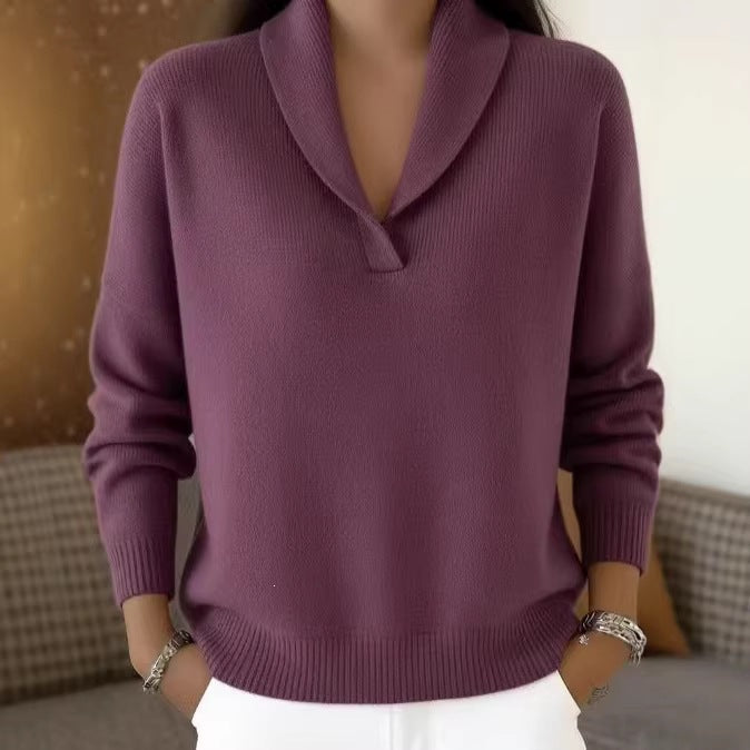 Purple sweater worn by a person with a blurred background