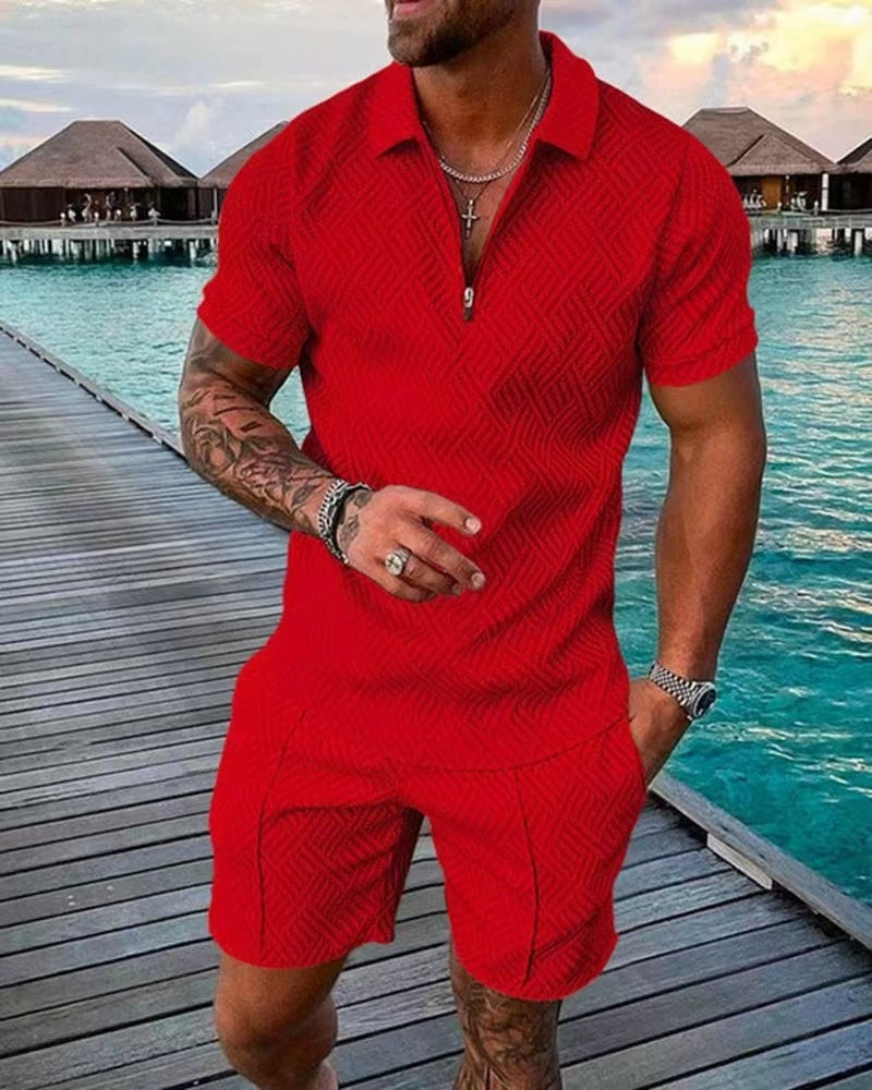 Man in a red outfit standing on a dock by water