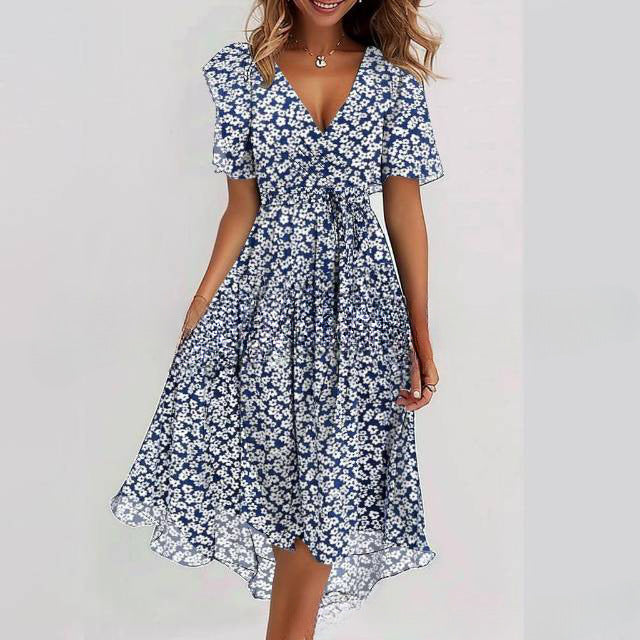 Woman wearing a navy floral dress on a plain background