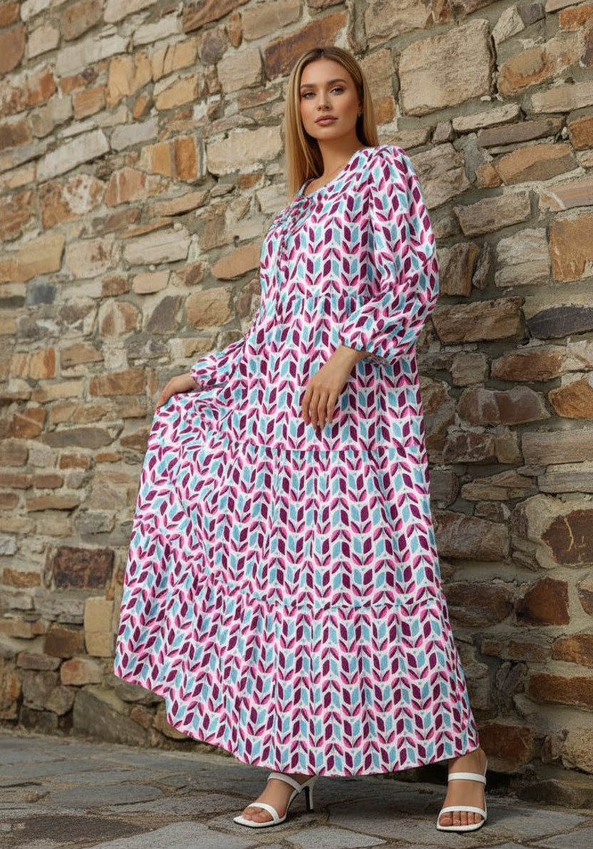Woman wearing a long, patterned dress on a white background