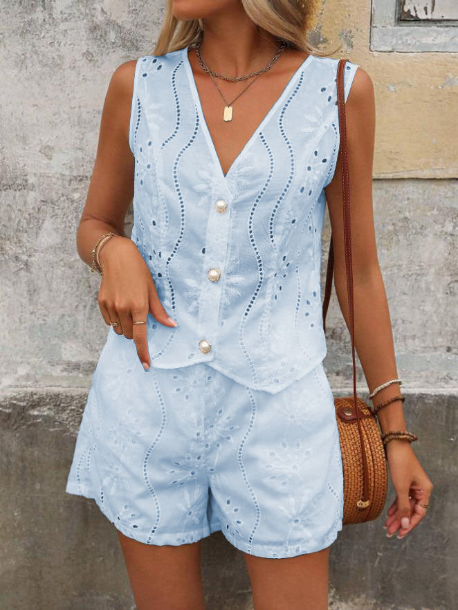 Woman wearing a light blue lace outfit with a neutral background