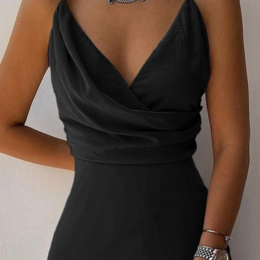 Black sleeveless dress with a deep neckline on a neutral background