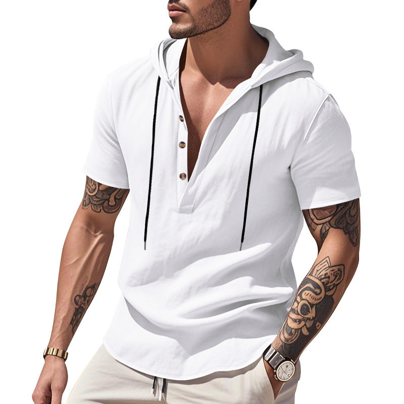 Man wearing a white short-sleeve hoodie with tattoos on arms against a white background