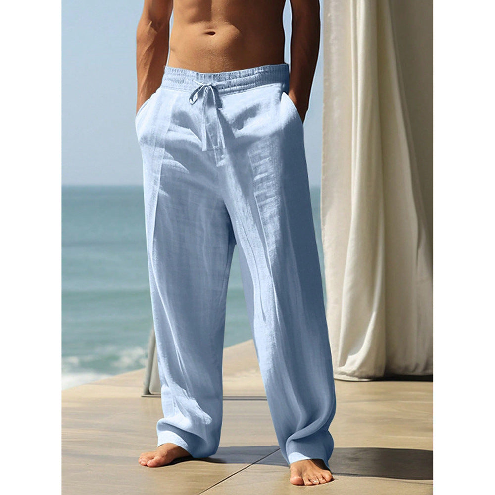Person wearing light blue pants standing on a wooden deck with ocean view
