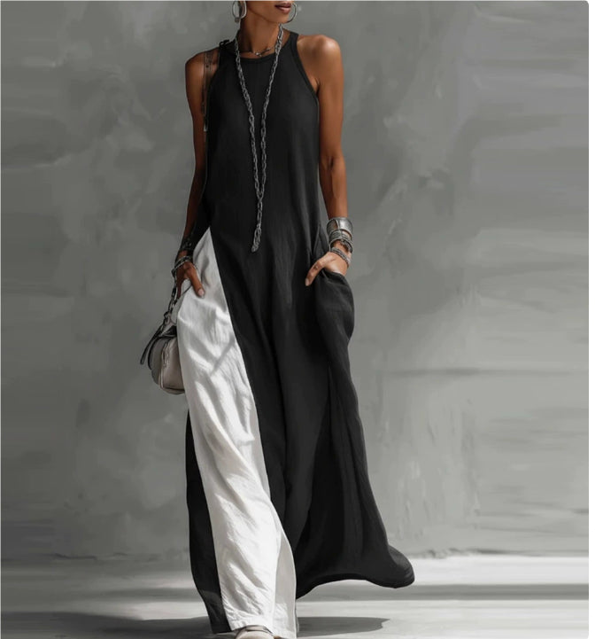 Person wearing a black and white dress against a gray background