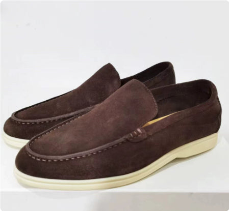 Pair of brown suede loafers on a white background