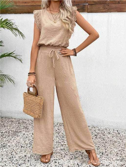 Woman in a beige wide-leg jumpsuit with lace sleeves, holding a straw handbag, ZA-Zola fashion