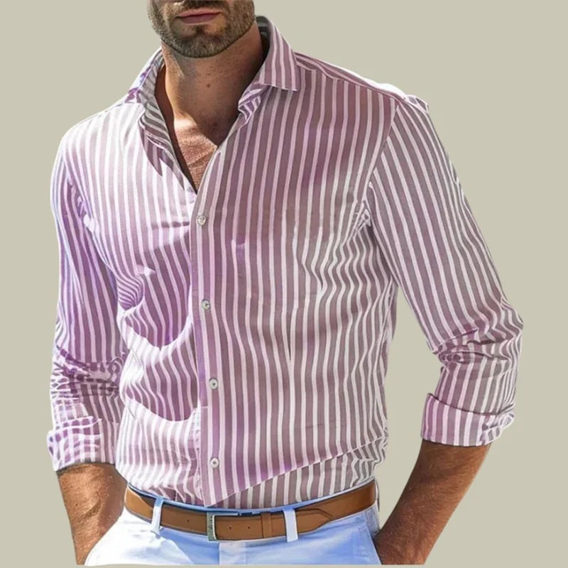 Man wearing a purple and white striped shirt with rolled-up sleeves on a plain background