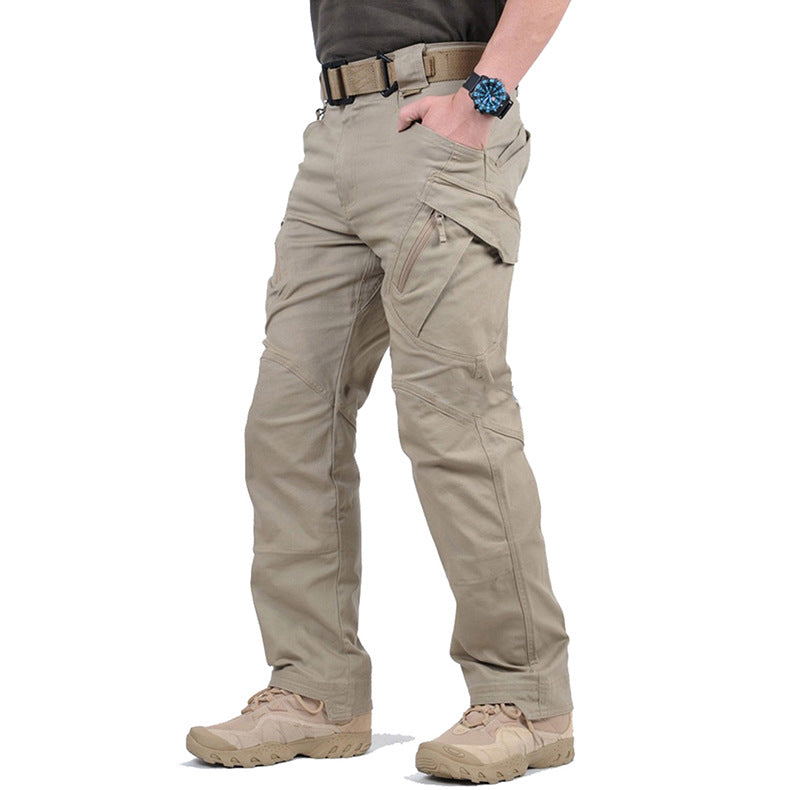 Person wearing beige tactical pants on a white background