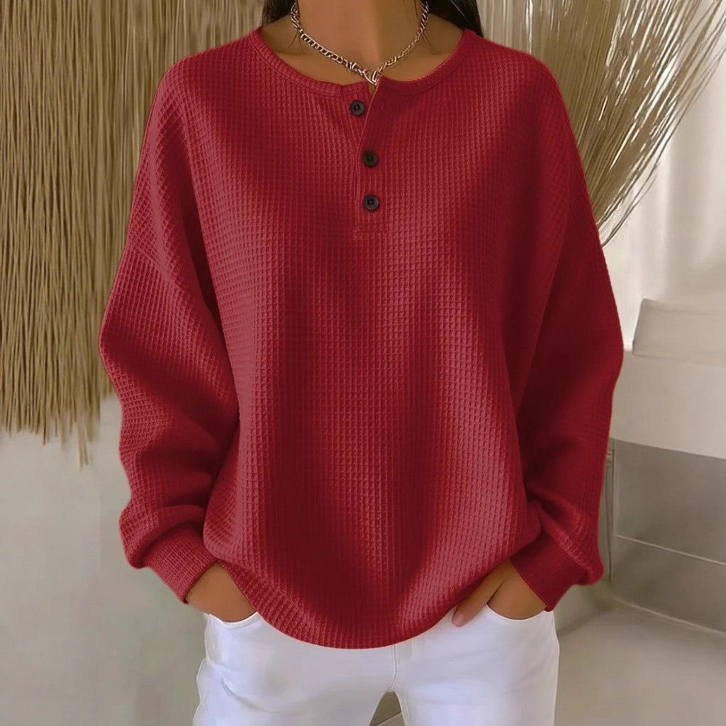 Red textured sweater worn by a person with a neutral background