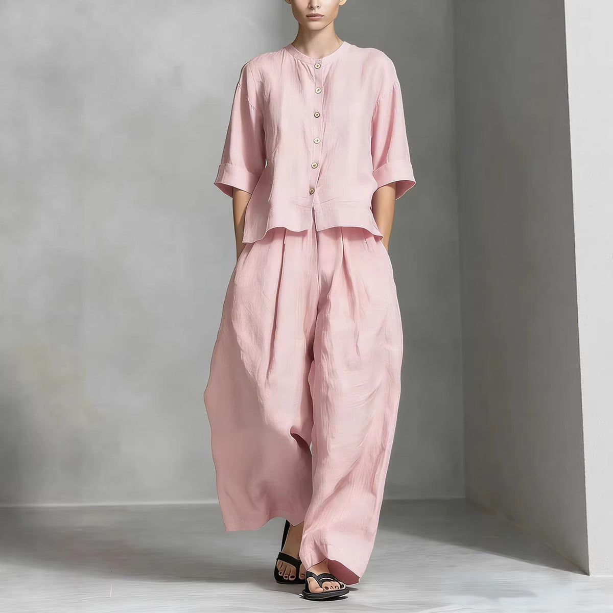 Person wearing a pink outfit against a gray background