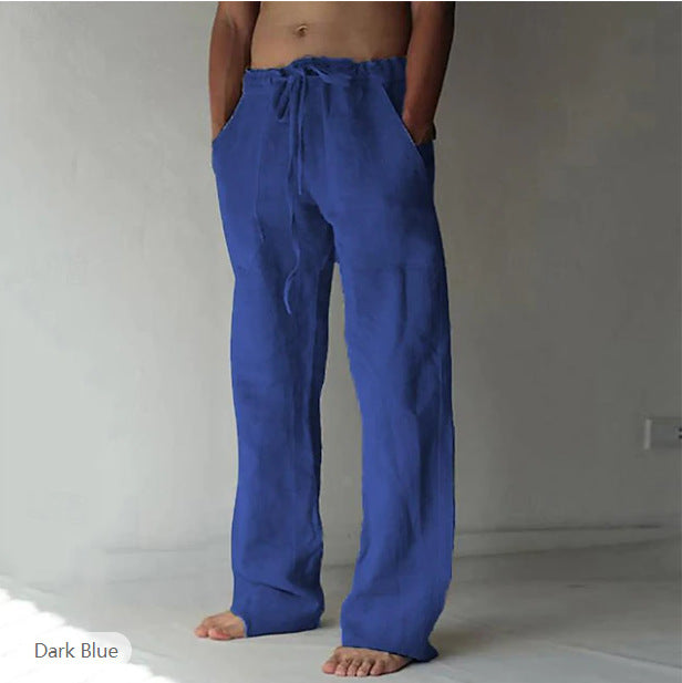 Person wearing dark blue pants against a plain background