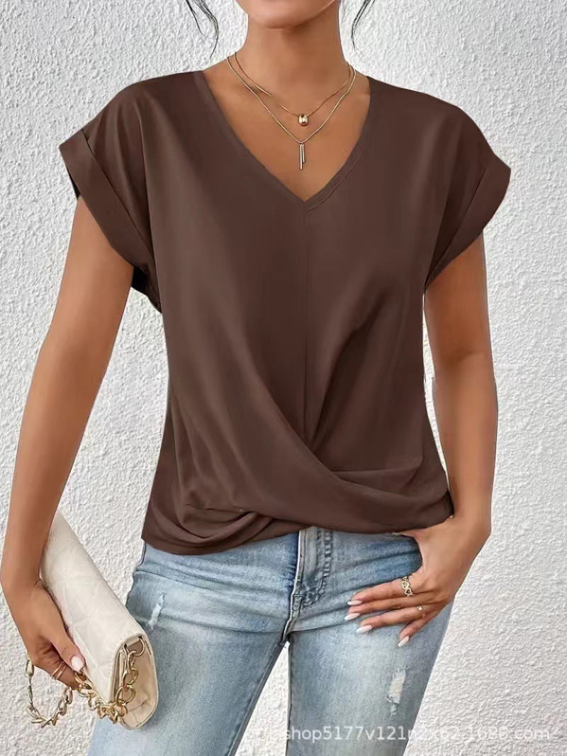 Woman wearing a brown top and blue jeans against a white background